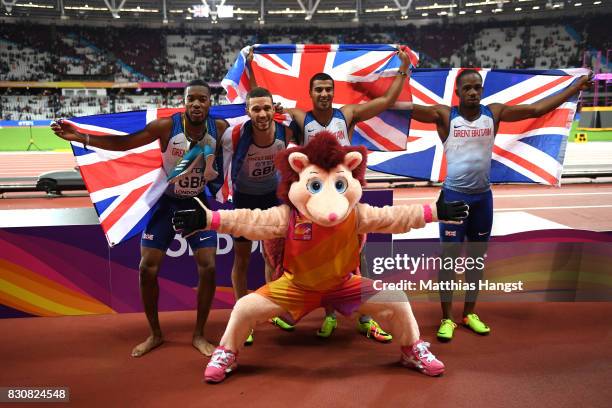 Chijindu Ujah, Adam Gemili, Daniel Talbot and Nethaneel Mitchell-Blake of Great Britain celebrate with Hero the Hedgehog winning gold in the Men's...