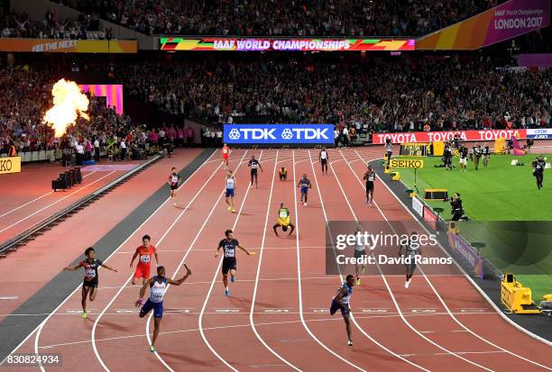 Nethaneel Mitchell-Blake of Great Britain crosses the finishline to win gold ahead of Christian Coleman of the United States as Usain Bolt of Jamaica...