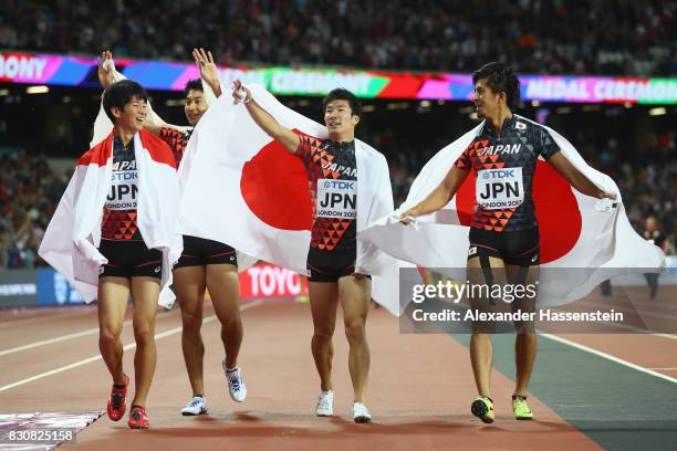 Shuhei Tada, Shota Iizuka, Yoshihide Kiryu and Kenji Fujimitsu of Japan celebrate winning bronze in the Men's 4x100 Relay final during day nine of...