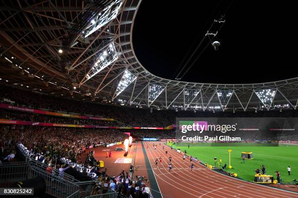 Nethaneel Mitchell-Blake of Great Britain crosses the finishline to win gold ahead of Christian Coleman of the United States as Usain Bolt of Jamaica...