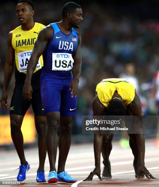 Justin Gatlin of the United States speaks to Usain Bolt of Jamaica after bolt fell in the Men's 4x100 Relay final during day nine of the 16th IAAF...