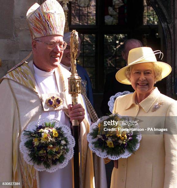 Britain's Queen Elizabeth II and the Archbishop of Canterbury, Doctor George Carey, stand outside the Deanery at Canterbury Cathedral after attending...