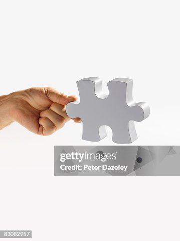 Hand Holding Last Jigsaw Piece High-Res Stock Photo - Getty Images