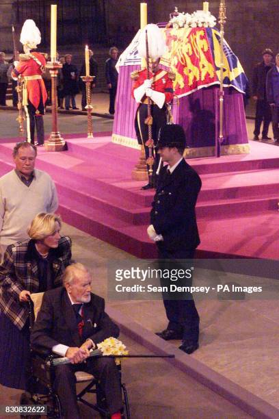 Veteran actor Sir John Mills pays his respect as he passes the coffin of Queen Elizabeth, the Queen Mother which lies in state in Westminster Hall,...