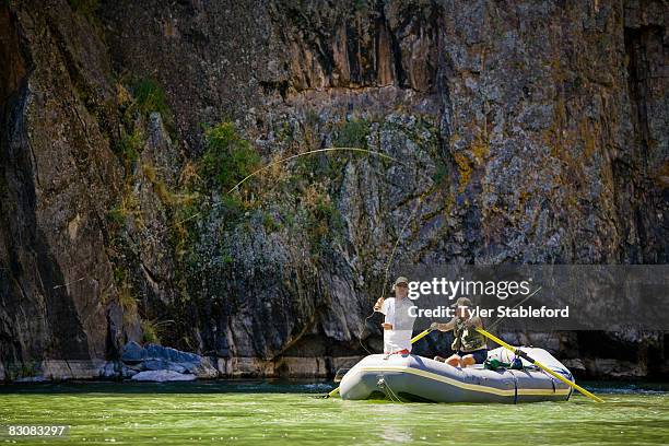 two men rafting and fly fishing. - montrose stock-fotos und bilder