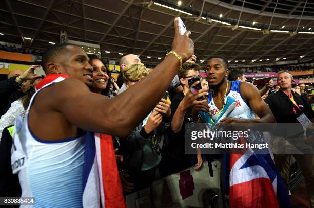 Chijindu Ujah and Nethaneel Mitchell-Blake of Great Britain celebrate winning gold in the Men's 4x100 Relay final during day nine of the 16th IAAF...