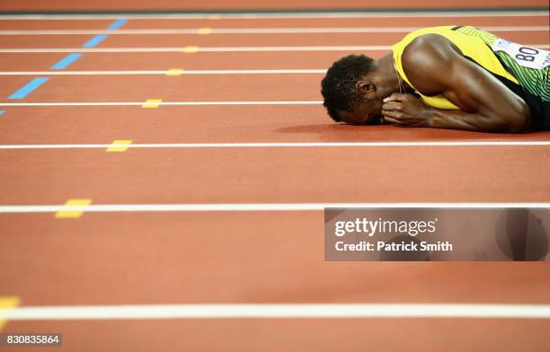 Usain Bolt of Jamaica reacts after falling to the track in the Men's 4x100 Relay final during day nine of the 16th IAAF World Athletics Championships...