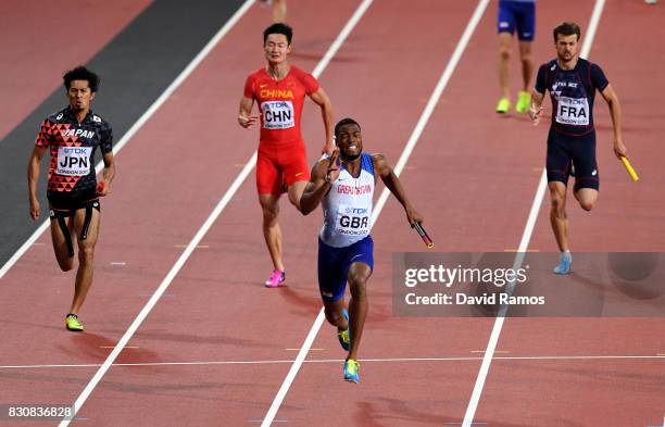 Nethaneel Mitchell-Blake of Great Britain crosses the finishline to win gold ahead of Kenji Fujimitsu of Japan, bronze, in the Men's 4x100 Relay...