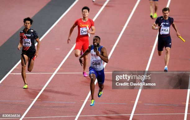 Nethaneel Mitchell-Blake of Great Britain crosses the finishline to win gold ahead of Kenji Fujimitsu of Japan, bronze, in the Men's 4x100 Relay...