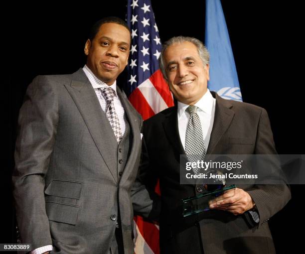 Rapper and entrepreneur Shawn "Jay-Z" Carter recieves his Global Leadership Award from US Ambassador to the United Nations Zalmay Khalilzad at the...