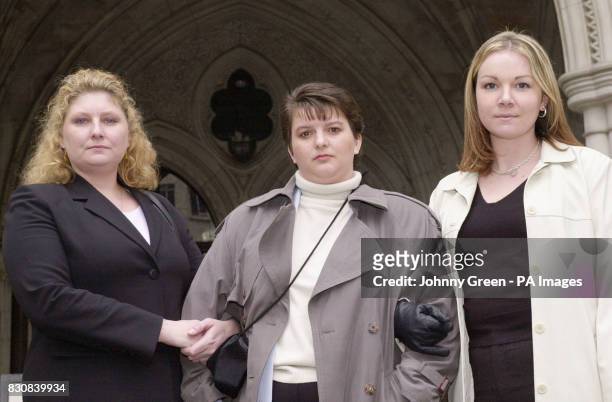 From left - Penny Cockings from Yeovil in Somerset, Trudi Banning from Leamington Spa and Michelle Markey from Reading, stand outside the High Court,...