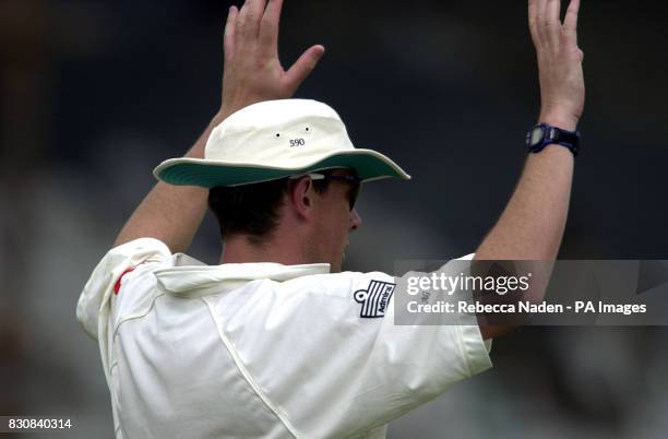 England's Ashley Giles acknowledges the other team players in the game against Board Presidents X1 at the Lal Bahadur Stadium, Hyderbad, India.