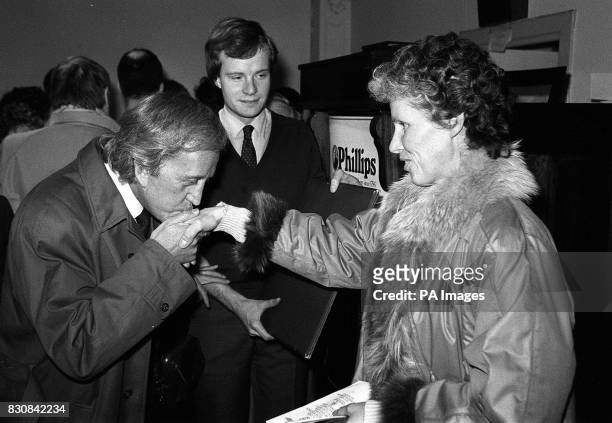Paul Raymond kisses the hand of Ursula Rudel widow of Nazi Germany's top fighter pilot Hans Ulrich Rudel after buying a medal citation signed by...