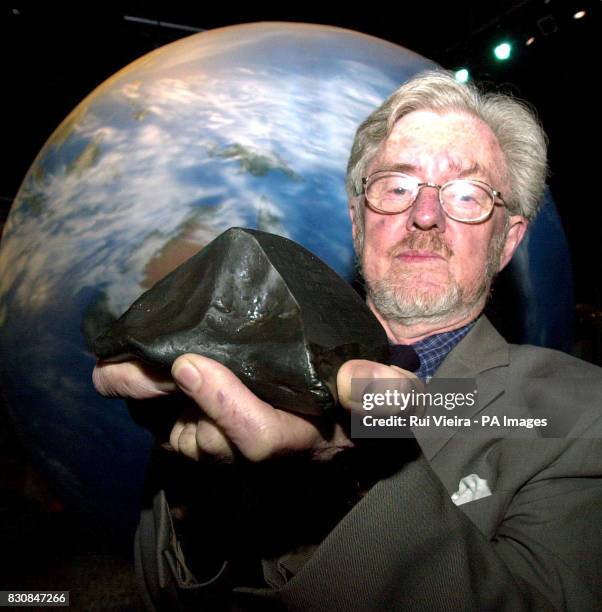 Dr Harry Atkinson, Chairman of the NEO Task Force, holds the only iron meteorite to fall in the UK in April 1876, at the NEO Information Centre,...
