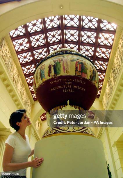 Sarah Calvert from the Royal Collection looks at one of the Royal treasures on display as part of a Golden Jubilee celebration, at the Queens...