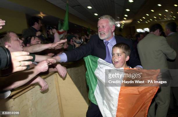 Candidate for North Kerry for Sinn Fein, Martin Ferris celebrates victory with 11-year-old Sean Lynch, holding the Irish flag at the Brandon Hotel in...