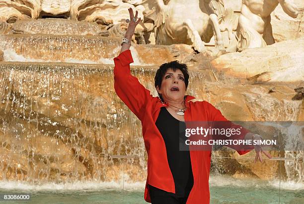 Singer Liza Minnelli makes a wish as she throws a coin in the Trevi fountain on October 2 in Rome during the promotion of her upcoming European tour....