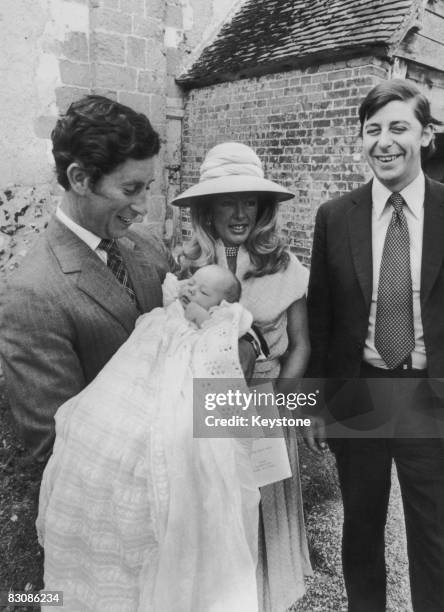 Prince Charles, Prince of Wales, holds his 9 week-old godson, Charles George Barrington Tryon, after the boy's baptism at the Church of St Andrews,...