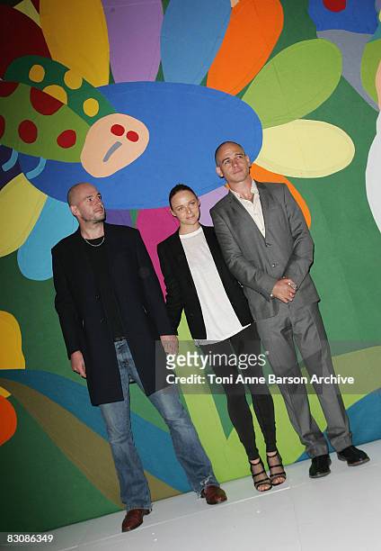 Stella McCartney poses with artists Jake and Dinos Chapman at the Stella McCartney fashion show during Paris Fashion Week at Carreau du Temple on...