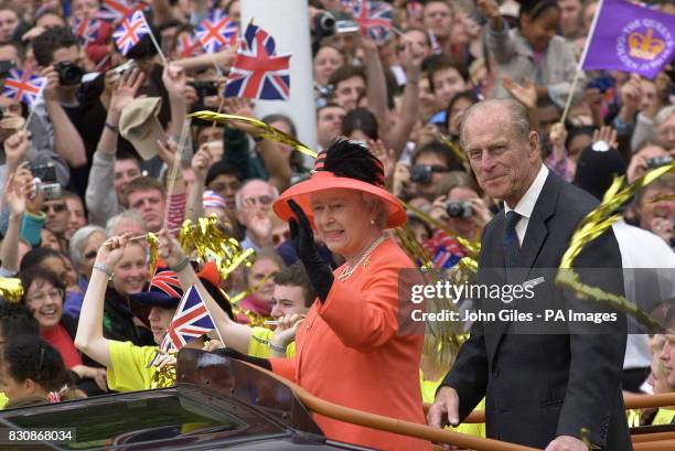 Queen Elizabeth II and her husband, the Duke of Edinburgh, ride along The Mall in an open-top car as they return from a banquet at Guildhall in the...