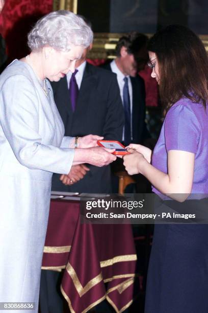 Queen Elizabeth II presenting a bronze medal to Helen Nightingale, aged 17, from Henley College, Henley-on-Thames Oxforshire, who was a winner in the...