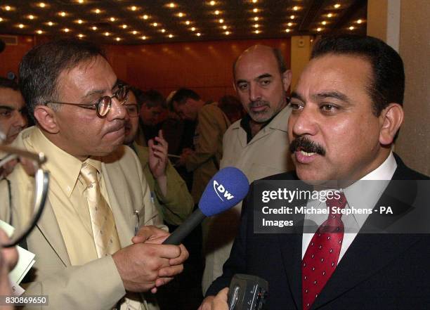 Brigadier Najib al-Salihi speaking to reporters as he arrives for the conference held for members of the Iraqi National Congress, former military...