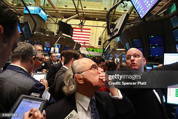 Traders work on the floor of the New York Stock Exchange October 2, 2008 in New York City. After passing in the Senate late Wednesday, the Bush...