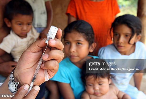 Nurse Justina Munoz Gonzalez vaccinating 4-month-old Olga Damaris outside her home near the remote village of San Pablo, near Murra in the Nueva...