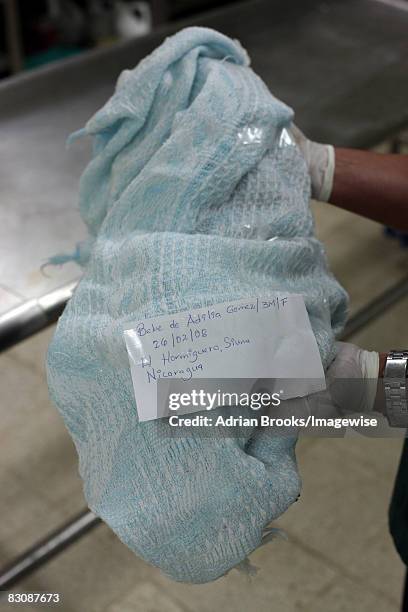 The abandoned body of 3-month-old Adilia Gomez Gradis in the morgue of La Mascota Hospital in Managua, Nicaragua. She died from pneumonia and was...