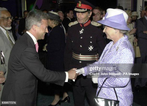 The Queen shakes hands with Alan Duncan, the Conservative MP for Rutland and Melton, as she toured the new National Space Centre, on the outskirts of...