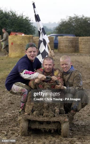 Steve Richardson with team mates Darren Whitehead and Robbie Jones, of the "Northerners kick grass" team, all from Holmfirth, Yorkshire, celebrate...