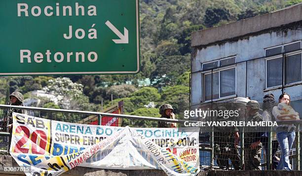 Brazilian soldiers patrol the main entrance of the "Rocinha" shantytown in Rio de Janeiro on September 19, 2008. Some 3,500 soldiers have been...