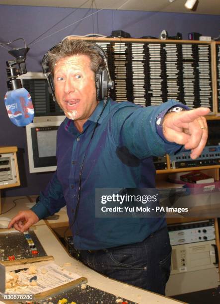 Capital Radio DJ Dr Fox points to Atomic Kitten's Jenny Frost after their cake fight, at the Capital Radio studio in London's Leicester Square. * Fox...