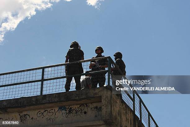 Brazilian soldiers patrol the main entrance of the "Rocinha" shantytown in Rio de Janeiro on September 19, 2008. Some 3,500 soldiers have been...