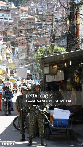 Brazilian soldiers patrol the main entrance of the "Rocinha" shantytown in Rio de Janeiro on September 19, 2008. Some 3,500 soldiers have been...