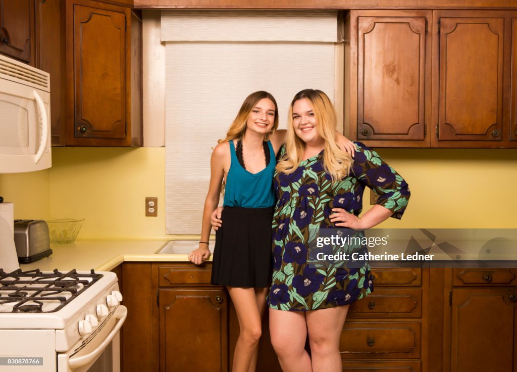 Sisters in grandmother's empty kitchen