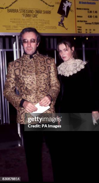 Actor Peter Sellers, wearing gold lame jacket and black trousers, escorts furniture designer, Miranda Quarry to the premiere of Funny Girl at the...