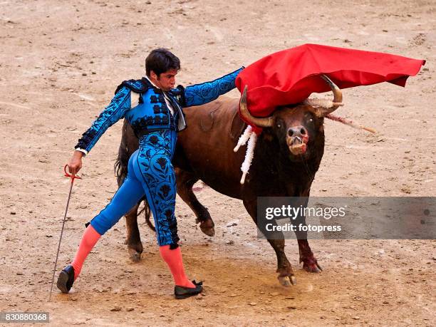 Spanish bullfighter Cayetano Rivera Ordonez performs with a Maria Loreto Charro Santos ranch fighting bull during the bullfighting as part of the La...