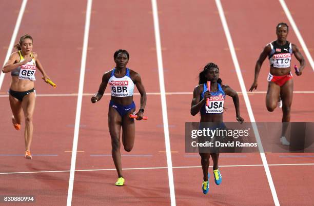 Tori Bowie of the United States and Daryll Neita of Great Britain race to the finish line in the Women's 4x400 Metres Final during day nine of the...