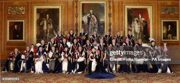 Queen Elizabeth II and the Duke of Edinburgh sit with the Knights and Ladies of the Garter in the Waterloo Room at Windsor Castle before a Garter...
