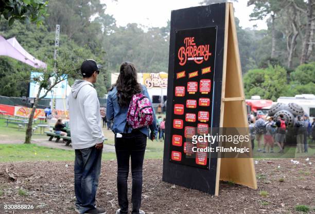 Fetivalgoers check out the lineup on The Barbary Stage during the 2017 Outside Lands Music And Arts Festival at Golden Gate Park on August 12, 2017...