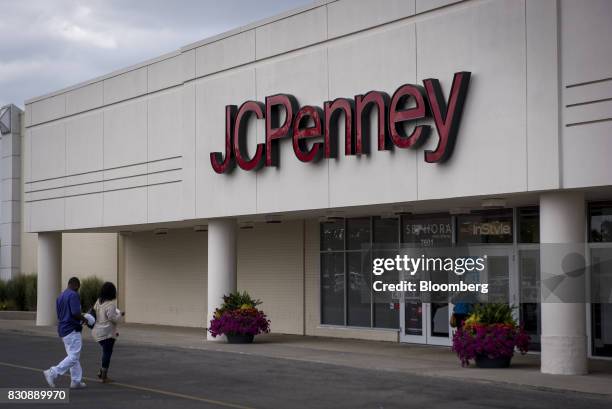 Shoppers walk to a JC Penney Co. Store in Chicago, Illinois, U.S., on Saturday, Aug. 12, 2017. On Friday morning, JC Penney posted a deeper loss than...