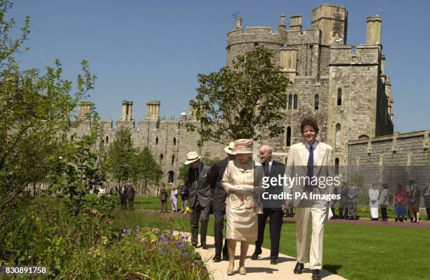Britain's Queen Elizabeth II, centre, accompanied by her husband the Duke of Edinburgh, obscured second left, and Sir Michael Peat, Keeper of the...