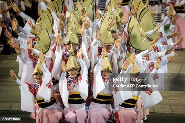 This picture taken on August 12, 2017 shows dancers of Ahou-ren performing during the Awa Odori festival in Tokushima. The four-day dance festival...