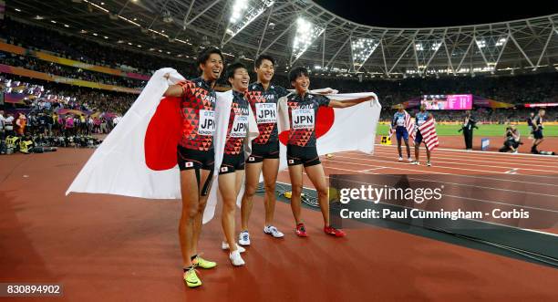 Shuhei Tada, Shota Iizuka, Yoshihide Kiryu and Kenji Fujimitsu of Japan celebrate winning bronze in the Men's 4x100 Relay final during day nine of...