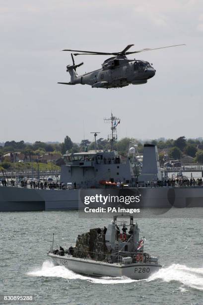 Some of the military equipment and service personnel that Britain's Queen Elizabeth II saw from the aircraft carrier HMS Ark Royal, when she watched...