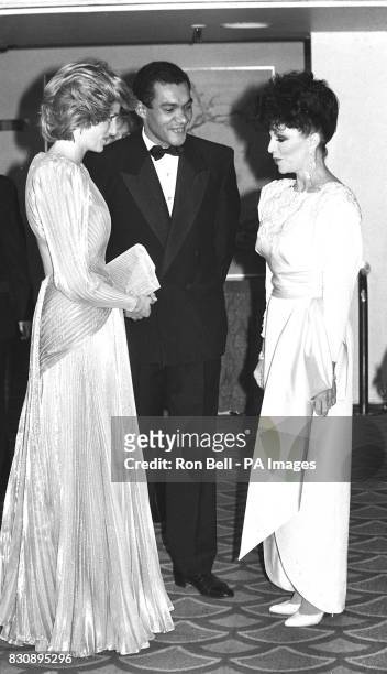 The Princess of Wales and Bruce Oldfield greet actress Joan Collins at a fashion show in aid of Dr Banardo's, Grosvenor House Hotel, London.