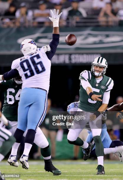 Christian Hackenberg of the New York Jets passes under pressure from Sylvester Williams of the Tennessee Titans in the second quarter during a...