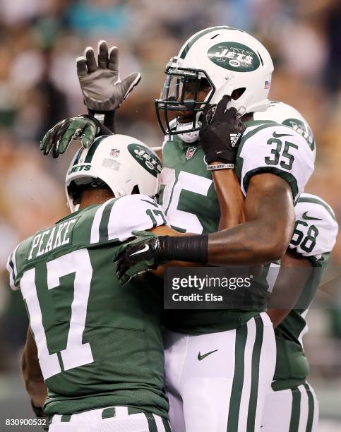 Charone Peake of the New York Jets is congratulated by teammate Elijah McGuire after Peake scored a touchdown in the first quarter against the...