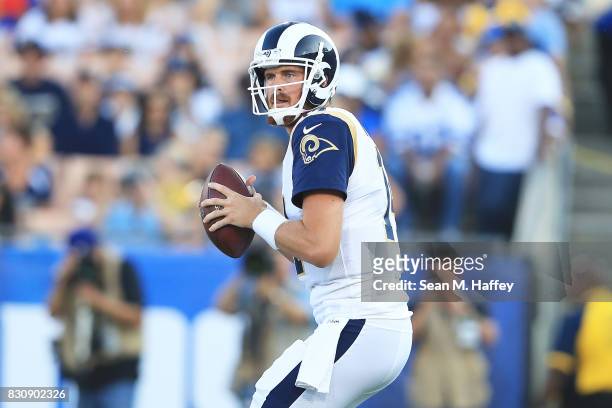 Sean Mannion of the Los Angeles Rams looks to pass during the preseason game against the Dallas Cowboys at the Los Angeles Memorial Coliseum on...